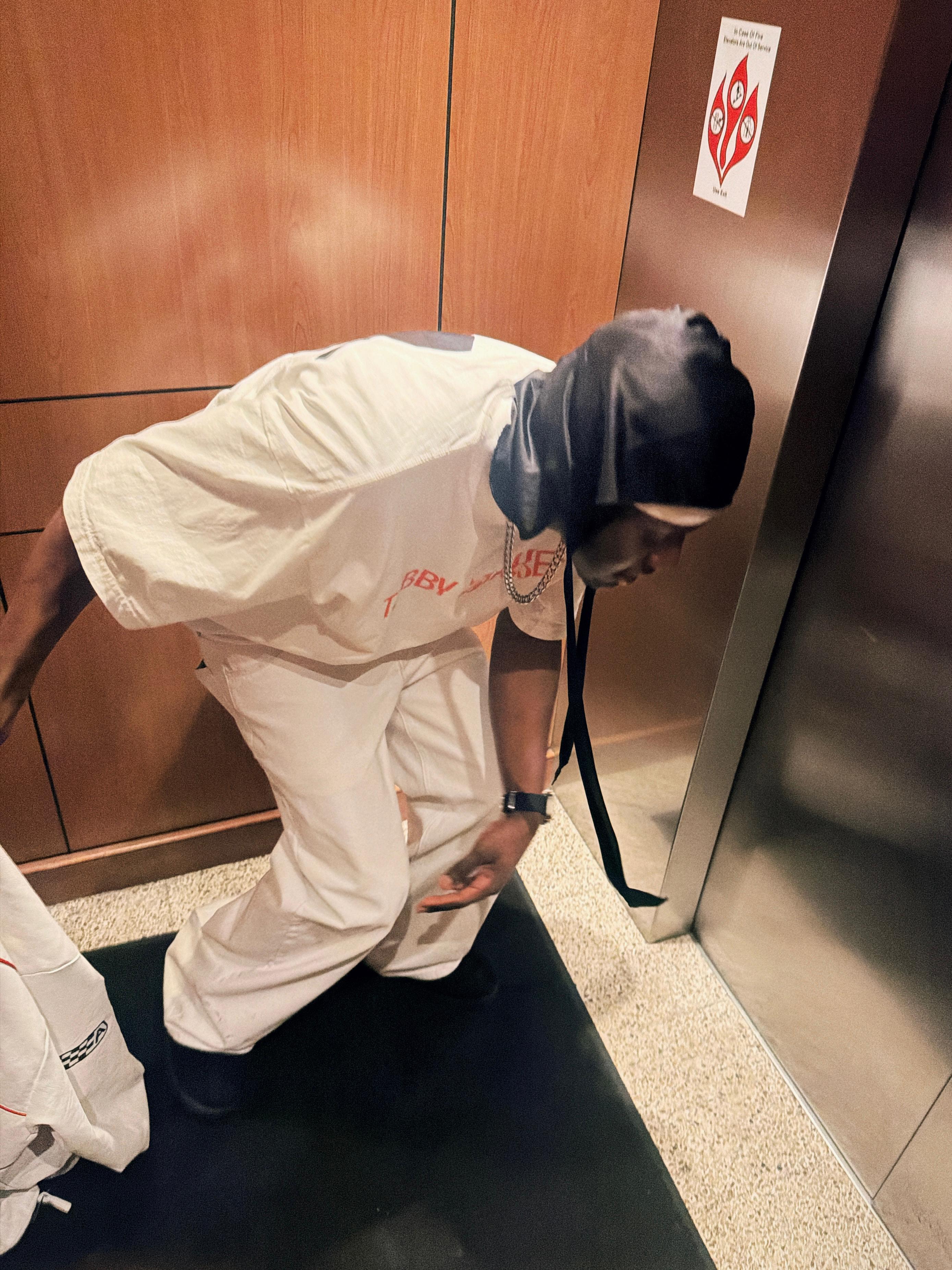 Tabby Blakes in a white outfit near an elevator